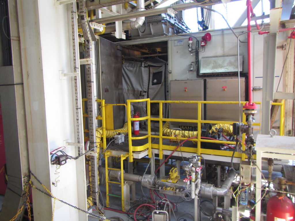 Industrial machinery and piping setup in a factory environment.